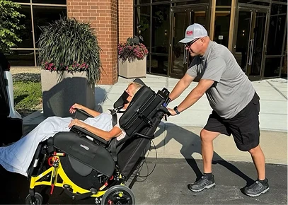 Proffesional-Staff-540x385px.jpg Man pushing man in wheelchair